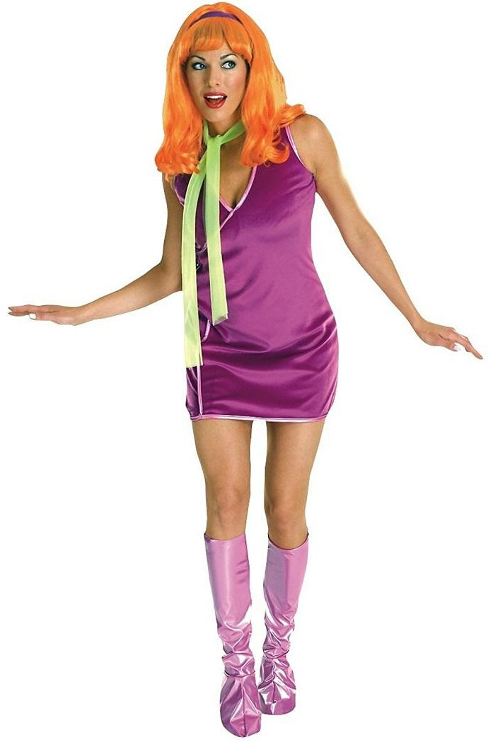 Person wearing a purple dress with a green tie and orange wig on a white background