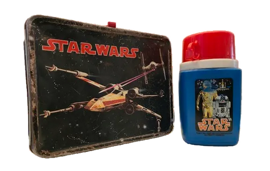 Black vintage metal Star Wars lunch box with X-Wing Fighter and  white and blue Thermos with red cup lid featuring Star Wars logo and CP30 and R2D2.