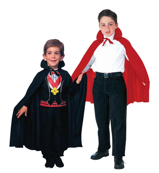 Two children in vampire costumes with red and black capes on a white background