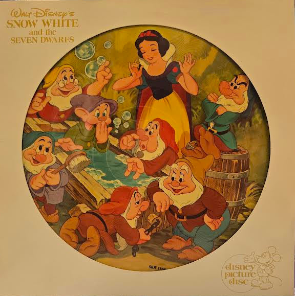Vintage 'Snow White and the Seven Dwarfs' vinyl record with full color disc illustration of Snow White and the Seven Dwarves.